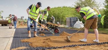 Prologis team members raking dirt on Impact Day 2014