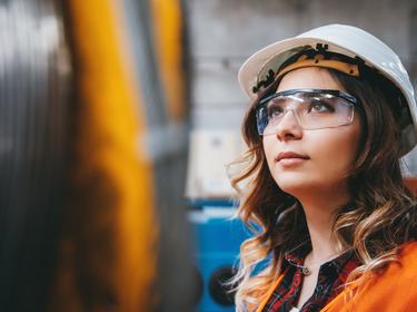 Woman with a hard hat and protective eyewear