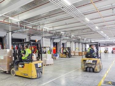 Forklifts inside of a warehouse