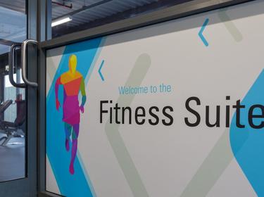 An interior wall with a graphic saying Fitness Suite