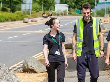 Three Prologis team members walking down the sidewalk talking to each other