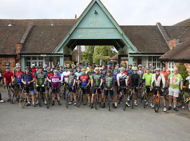 group photo of riders in the Prologis 100 cycle event