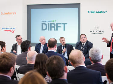 Panelists at DIRFT looking at a speaker with a microphone Panelists at DIRFT looking at a speaker with a microphone